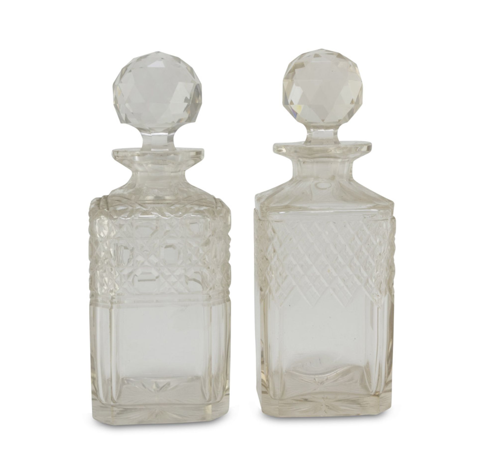 A Pair of Liqueur Bottles, EARLY 20TH CENTURY in glass cut to diamond points. Measures cm. 23 x