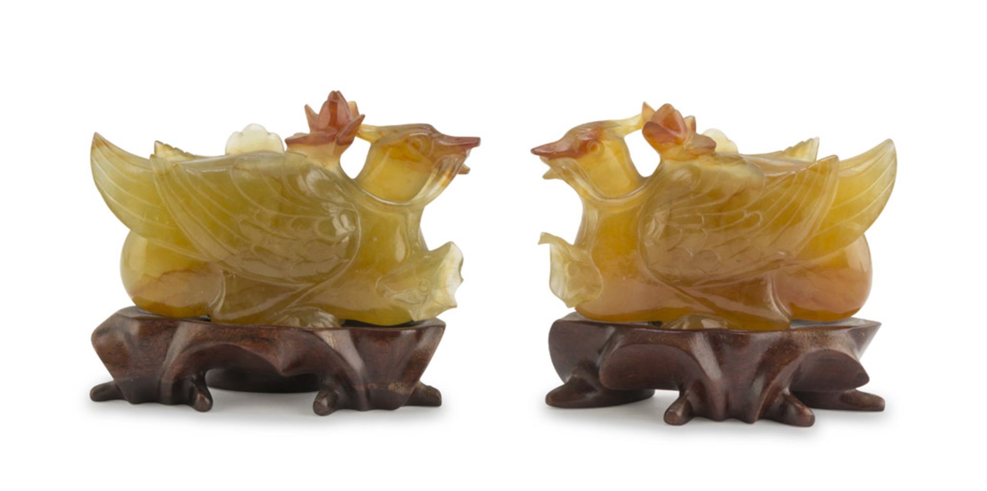 A PAIR OF CHALCEDONY SCULPTURE, CHINA 20TH CENTURY representing two ducks with lotus flowers.