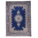 KIRMAN CARPET, FIRST HALF OF THE 20TH CENTURY with bog flower medallion, in the center field on blue