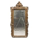 MIRROR IN GILDED WOOD AND PLASTER, 19TH CENTURY frame with motifs of scrolls, leaves and curls.