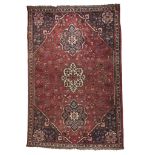 HAMADAN CARPET, EARLY 20TH CENTURY triple floral medallion, with secondary motifs of simbologies and