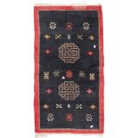 TIBETAN CARPET, EARLY 20TH CENTURY double meander medallion and secondary motifs of rosettes and