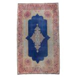 RARE KIRMAN CARPET, EARLY 20TH CENTURY guilloche medallion, in the center field on blue ground.