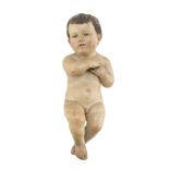 PUTTO FIGURE IN PLASTER, 19TH CENTURY in polychromy, with the hands to the breast. Measures cm. 36 x