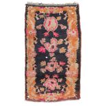 CHINESE-TIBETAN CARPET, LATE 19TH CENTURY triple flower medallion on black ground. Measures cm.