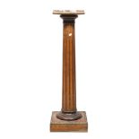 COLUMN IN CHERRY TREE, EARLY 20TH CENTURY with superior top in veined red marble, fluted body,