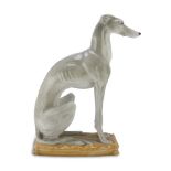 SCULPTURE IN CERAMICS, 20TH CENTURY in polychromy, representing a dog in seated pose. Pillow base.