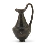 OINOCHOE IN BUCCHERO, 6TH-5TH CENTURY B.C. with ribbon handle, conical body troncoconico, lobed