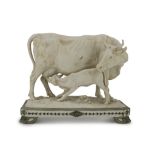 GROUP IN BISCUIT, 20TH CENTURY representing cow with calf. Rectangular base in green enamel.