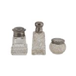 THREE PERFUME BOTTLES IN GLASS AND SILVER, PUNCH LONDON 1911 chiseled covers with family initials.