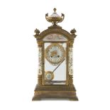 TABLE CLOCK IN GILDED METAL AND PORCELAIN, LATE 19TH CENTURY temple case, dial, upright and finial