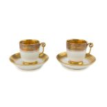 A PAIR OF PORCELAIN CUPS, EARLY 19TH CENTURY in white enamel and gold, decorated with floral