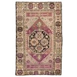 RARE ANATOLIC GHIORDES CARPET, 19TH CENTURY with stars medallion and secondary motifs of flowers and