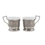 A PAIR OF CUPS IN SILVER AND PORCELAIN, EARLY 20TH CENTURY silver cup holders engraved with leafy