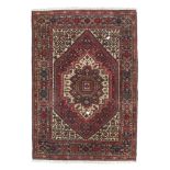 SMALL HAMADAN CARPET, EARLY 20TH CENTURY tightly woven with red medallion and secondary Herati