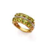 ATTRACTIVE RING in silver plated in gold 14 kts. with line of natural peridots and Cambodian