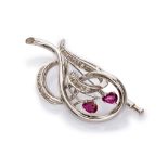 FANTASY BROOCH in white gold 18 kts., with wanted decorated with file of diamonds and rubies