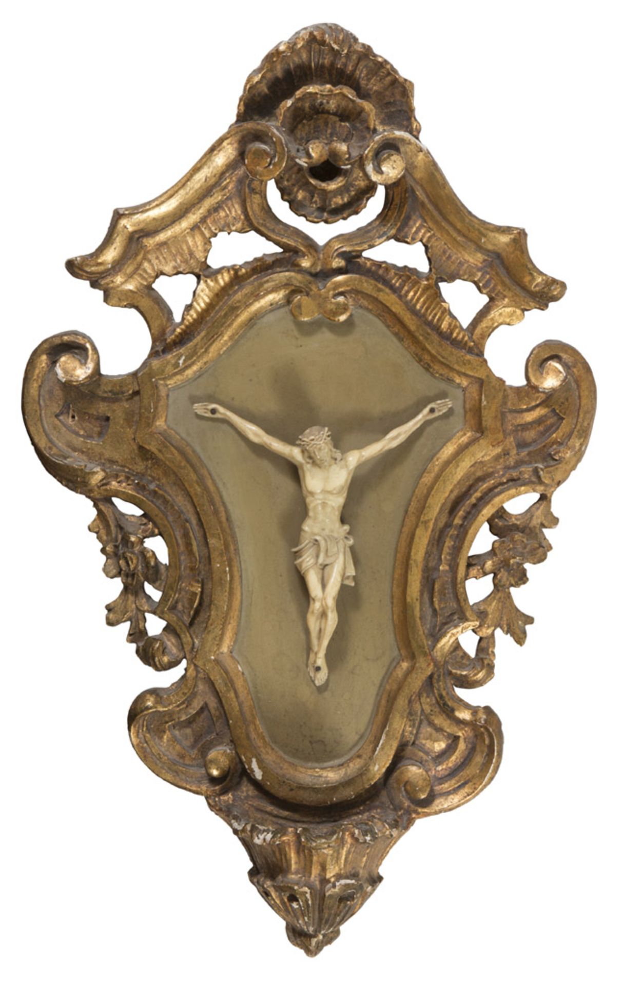 SMALL CHRIST IN IVORY, END 18TH CENTURY applied on cartouche frame in carved giltwood. Total