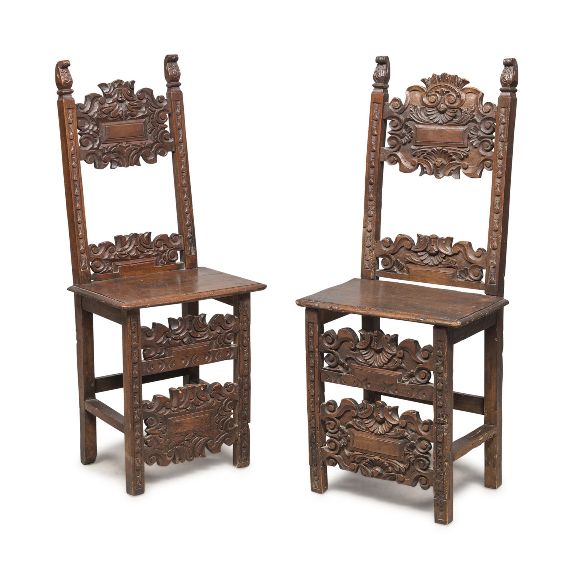 A PAIR OF WALNUT CHAIRS, CENTRAL ITALY, 17TH CENTURY splat backs carved to floral motifs,