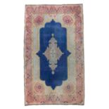 Rare Carpet KIRMAN, EARLY 20TH CENTURY with medallion arabescato, in the center field on blue