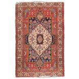 RARE FEHERAGAN CARPET, EARLY 20TH CENTURY medallion with shoots of flowers on white ground in the