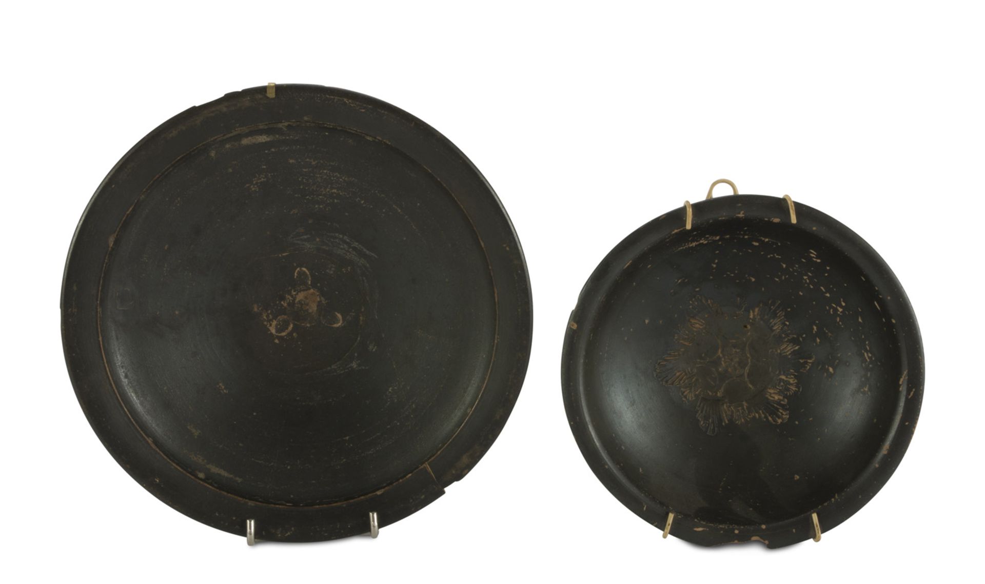 TWO CERAMIC DISHES, 20TH CENTURY black varnished. Measures cm. 6 x 22 and cm. 17,5.   DUE
