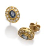 EARRINGS in yellow gold 18 kts., with central sapphires edged by diamonds. Sapphires ct. 0.60,