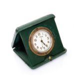 TRAVEL CLOCK in gilded metal complete of box in green leather. Diameter cm. 8. Defects. OROLOGIO