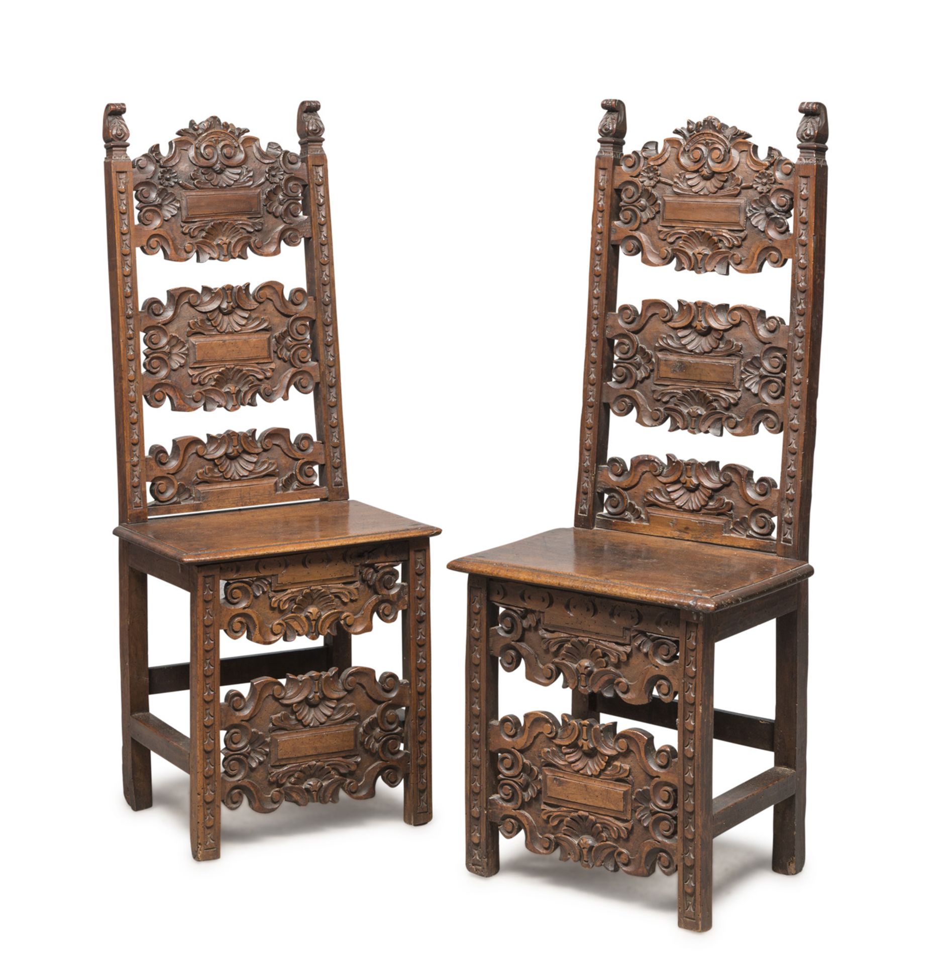 A PAIR OF WALNUT CHAIRS, CENTRAL ITALY, 17TH CENTURY cartouche back carved to floral motifs and