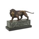 BRONZE LION SCULPTURE, LATE 19TH CENTURY with gilded patina, rectangular base in green granite and