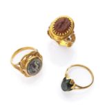 THREE RINGS with mounts in yellow gold 18 kts., antique engraved carnelian with figure of draped