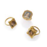 THREE ATTRACTIVE RINGS with mount in yellow gold 18 kts., and small miniatures representing faces of