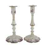 A PAIR OF CANDLESTICKS IN PORCELAIN, GINORI 18TH CENTURY decorated with racemes in relief and