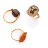 THREE RINGS with mount in yellow gold 18 kts., with antique engraved hard stones and carnelian