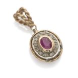 PENDANT in yellow gold 18 kts. and silver, oval shape with central ruby edged by rose cut