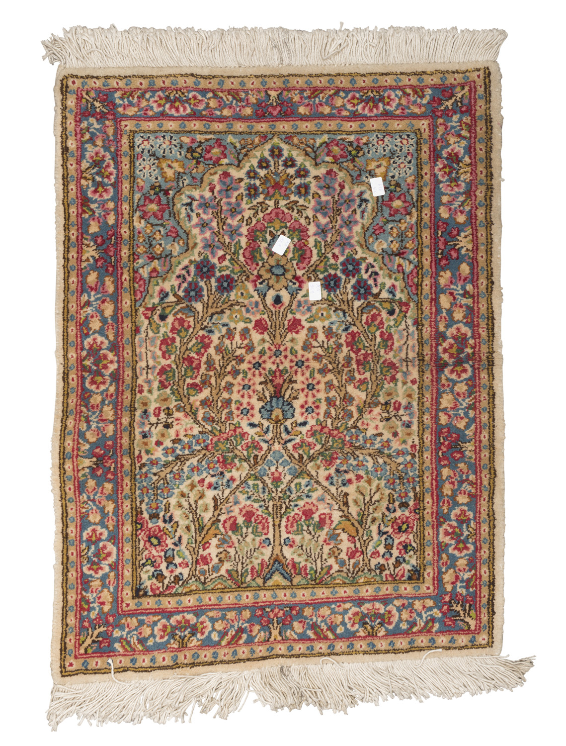 BED RUG KIRMAN, MID- 20TH CENTURY with flower design in the center field on white ground. Measures