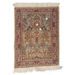 BED RUG KIRMAN, MID- 20TH CENTURY with flower design in the center field on white ground. Measures