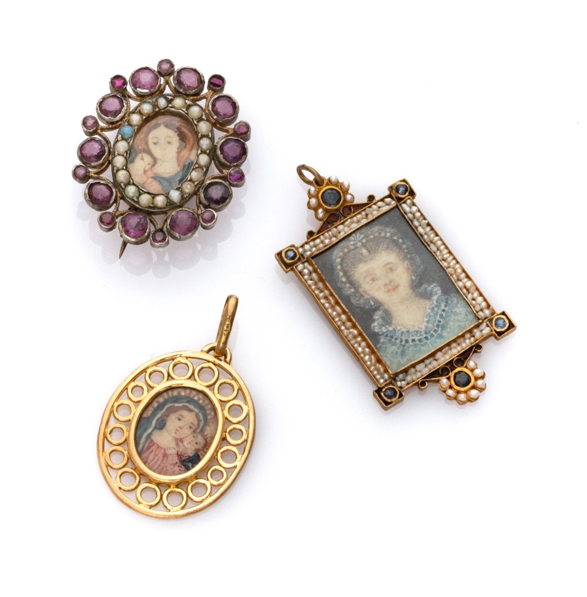 THREE PENDANTS with mounts in yellow gold 18 kts. and silver '800, adorned by micro pearls and