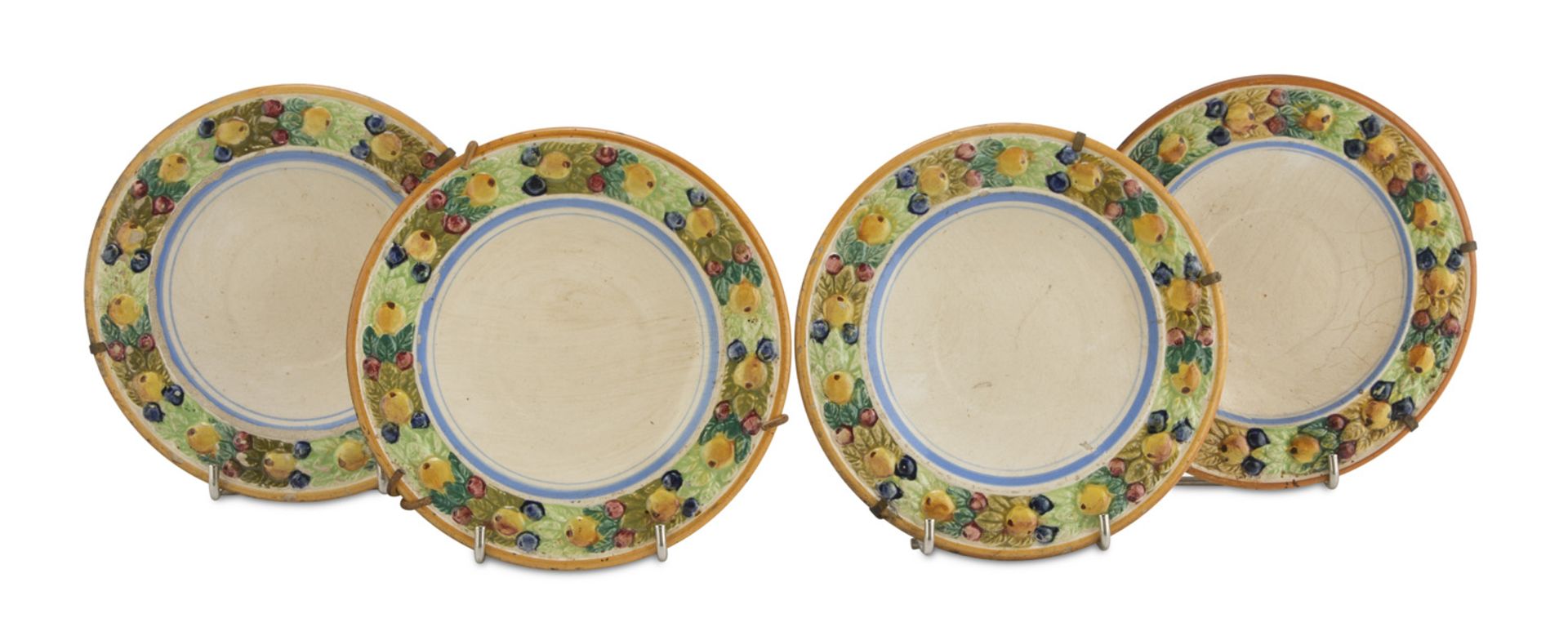 FOUR MAIOLICA DISHES, CANTAGALLI EARLY 20TH CENTURY white and polychrome enameled, edge decorated