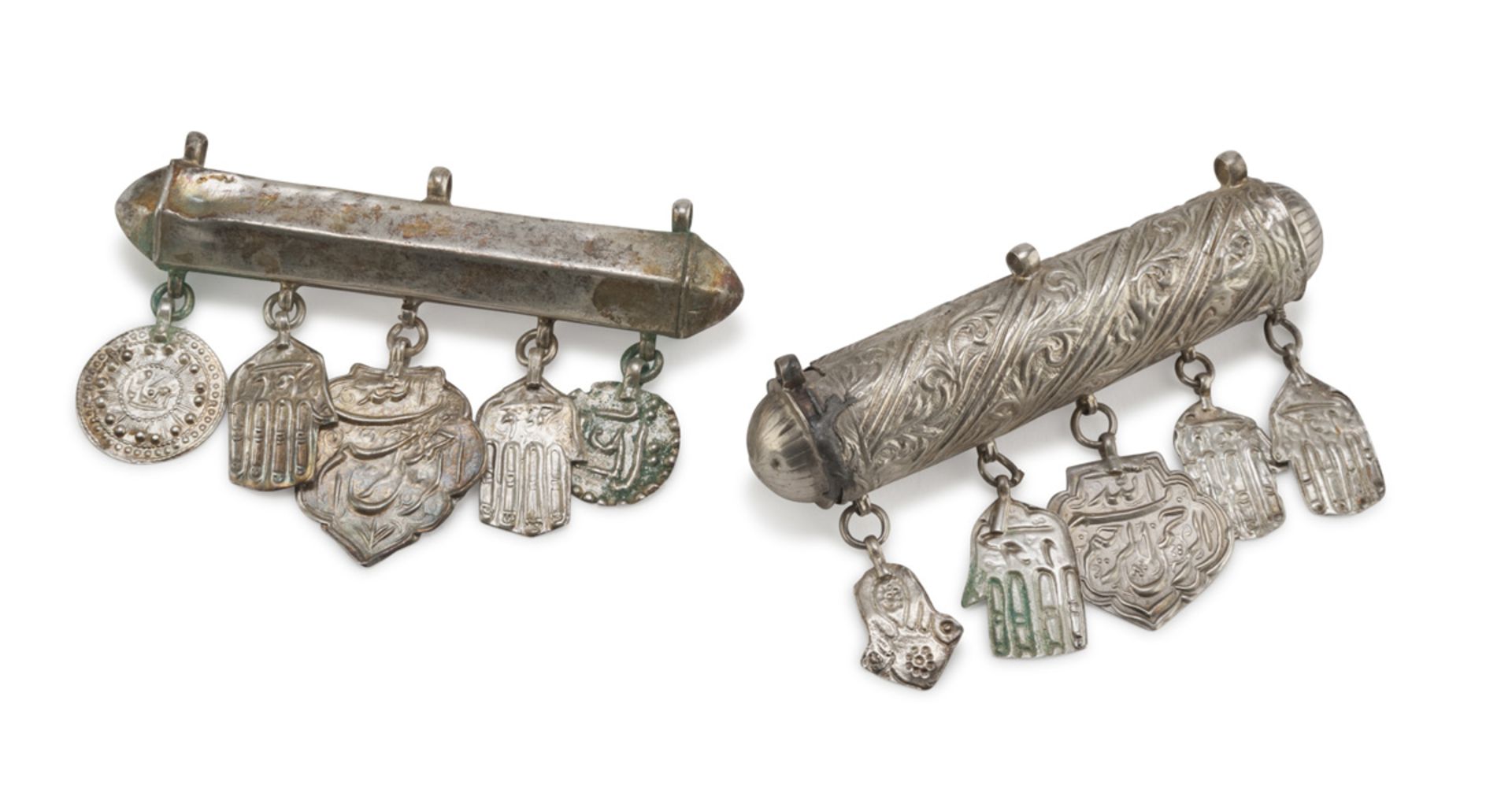 TWO INFANT NECKLACES IN SILVER, PROBABLY PERSIA 20TH CENTURY with pendants of various shapes. Length