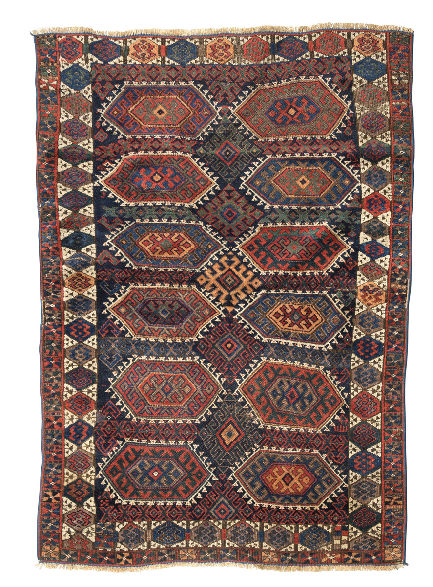 KAZAK CARPET, EARLY 20TH CENTURY with hooked octagons design and secondary motifs of rhombuses in