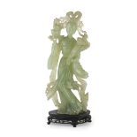 BIG SERPENTINE SCULPTURE, CHINA 20TH CENTURY representing He Xiangu holding a big lotus and a