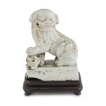 WHITE PORCELAIN SCULPTURE, CHINA 19TH CENTURY representing a Buddhist lion in protective pose.