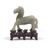 JADE SCULPTURE, CHINA 20TH CENTURY representing a trotting horse. Base in shaped wood. Measures
