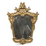 GILTWOOD MIRROR, EARLY 20TH CENTURY of eighteenth-century style, sculpted to leaves, flowers and