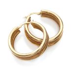 PAIR OF EARRINGS in yellow gold 18 kts., smooth and grained bands. Diameter cm. 3, total weight