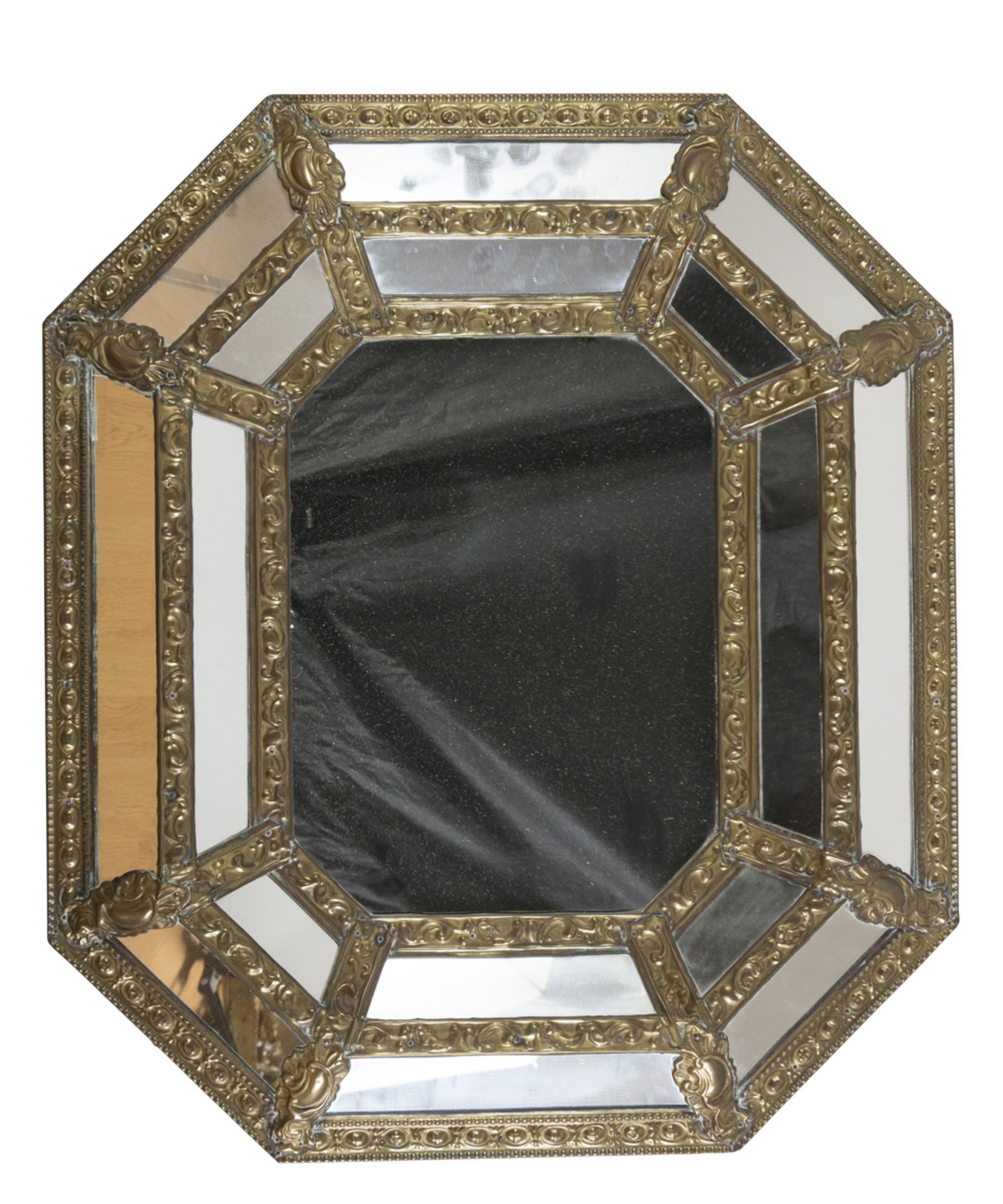 MIRROR IN GILDED METAL, HOLLAND EARLY 20TH CENTURY with embossed edges. Measures cm. 64 x 56.