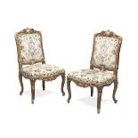 A PAIR OF WALNUT CHAIRS, PERIOD NAPOLEON III entirely sculpted to leaves and vegetal motifs, with