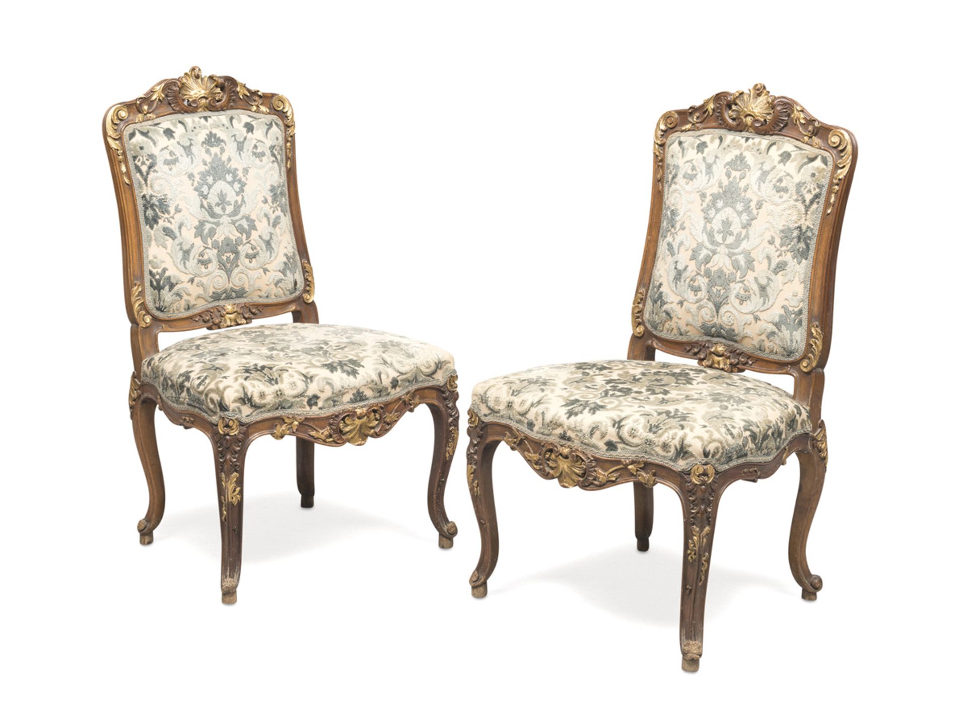 A PAIR OF WALNUT CHAIRS, PERIOD NAPOLEON III entirely sculpted to leaves and vegetal motifs, with