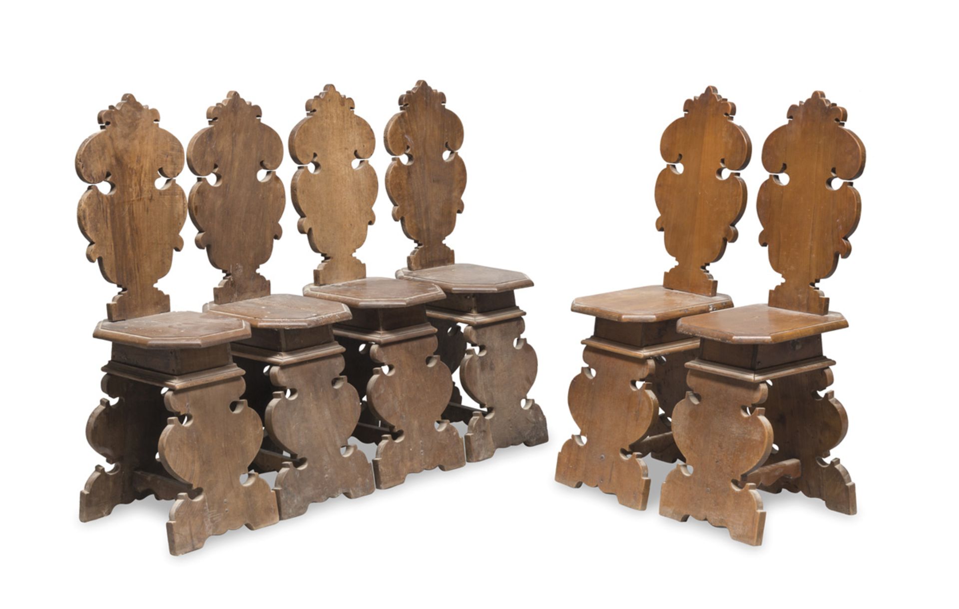 SIX WALNUT CHAIRS, LATE 19TH CENTURY with sculpted and flat legs of same carving. Polygonal seats.